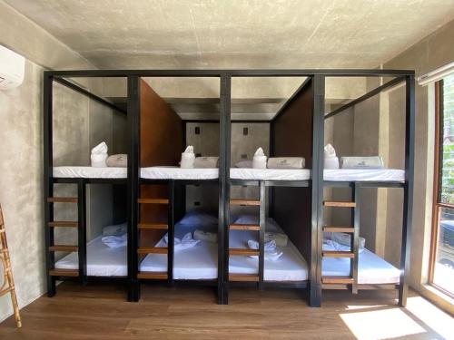 a group of bunk beds in a room at Shorebreak Hostel San Juan La Union in san juan la union