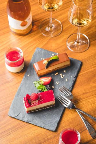 a table with a plate of food and glasses of wine at InterContinental Budapest by IHG in Budapest