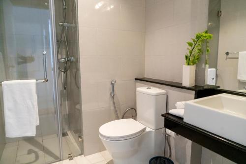 a bathroom with a shower and a toilet and a sink at Oceanfront Galle Apartment L4-10 in Galle