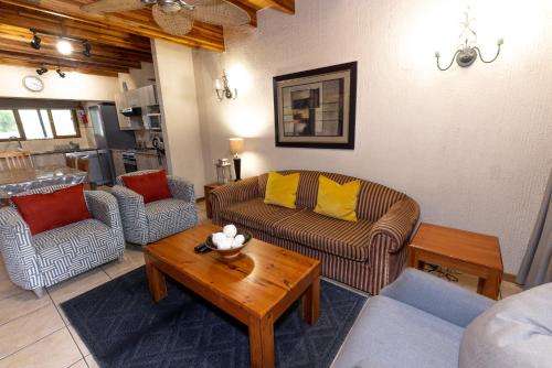 a living room with couches and a coffee table at Legend Safaris 257A - in Kruger Park Lodge in Hazyview