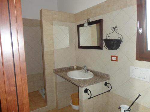 a bathroom with a sink and a shower at Agriturismo Gavina Pes in Campanedda