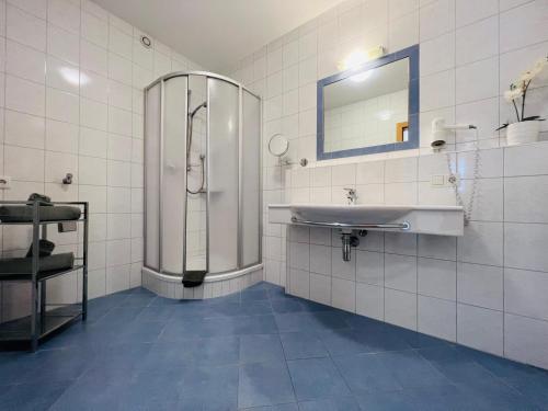 a bathroom with a shower and a sink at Appart Kofler in Gerlos