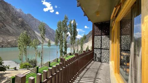 a building with a balcony with a view of a lake at Famree Resort Hunza in Hunza Valley