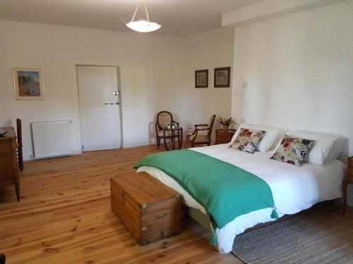 1 dormitorio con 1 cama grande y suelo de madera en l'Airial de Larroque, en Soustons