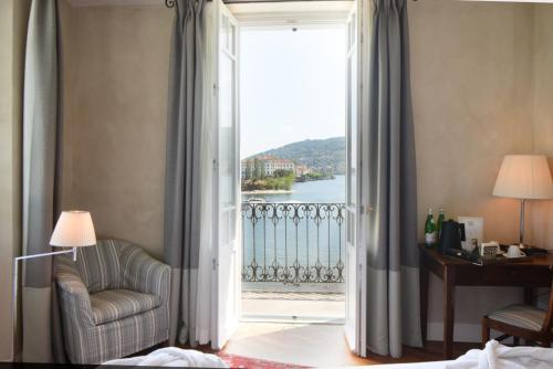 a room with a door open to a balcony with a view at Albergo Ristorante Il Verbano in Stresa