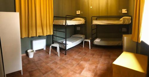a room with three bunk beds in a room at Casa Conte Rosso in Avigliana