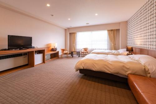 A bed or beds in a room at Yuzawa Toei Hotel