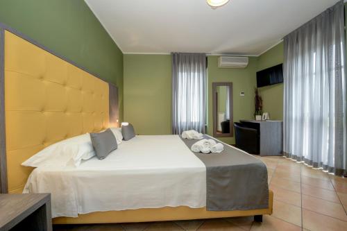 a bedroom with a large bed in a room at Albergo Locanda Primavera in Rodengo Saiano