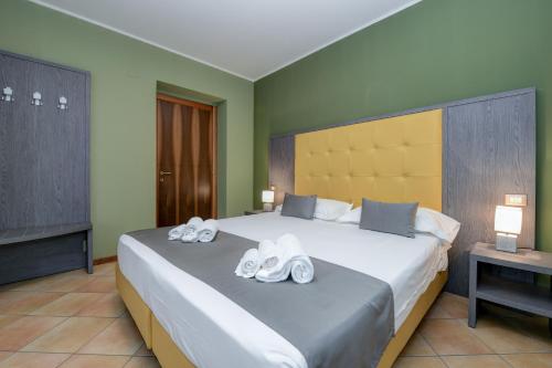 a bedroom with a large bed with towels on it at Albergo Locanda Primavera in Rodengo Saiano
