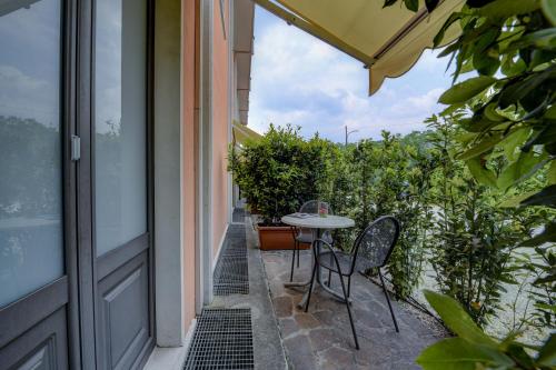 a patio with a table and chairs on the side of a building at Albergo Locanda Primavera in Rodengo Saiano