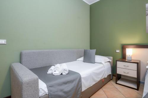 a bedroom with a bed and a table with shoes on it at Albergo Locanda Primavera in Rodengo Saiano