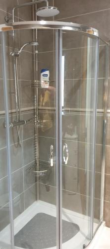 a shower with a glass door in a bathroom at Solheimir at Strathmore Golf Course in Blairgowrie