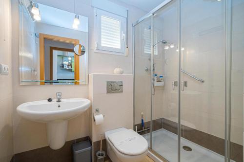 a bathroom with a sink and a toilet and a shower at Apartament Altea Spaniahome in Altea