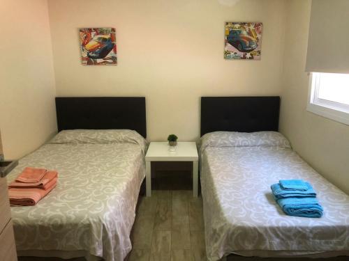 En eller flere senge i et værelse på Apartamentos Albeniz