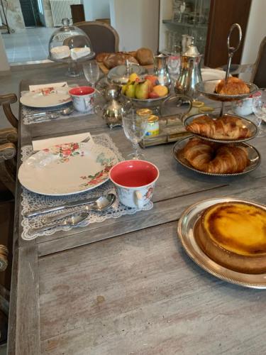 a table topped with plates of food and pastries at La Closeraie Saint Girons in Saint-Girons-dʼAiguevives