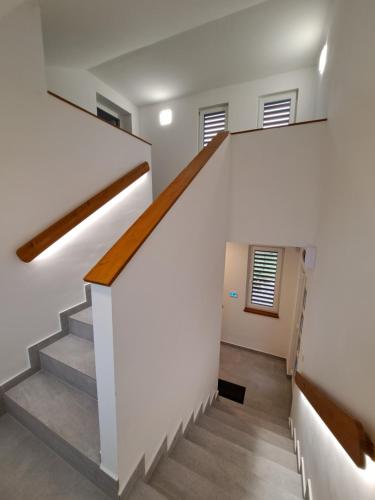 a staircase in a house with white walls and wooden floors at Villa Field6 in Révfülöp