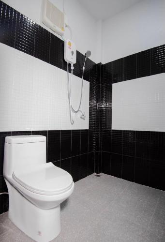 a bathroom with a toilet and a shower at กาลครั้งหนึ่ง @ สิชล รีสอร์ท (Once upon a time@Sichon Resort) in Sichon