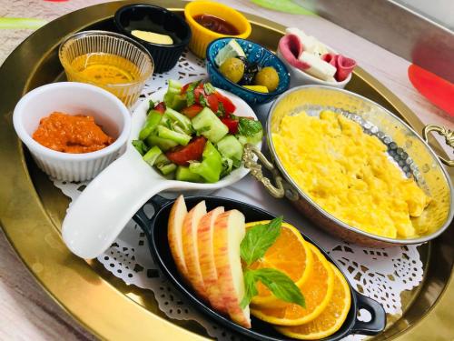 a tray of food with fruits and vegetables on it at Suadhan Hotel in Istanbul