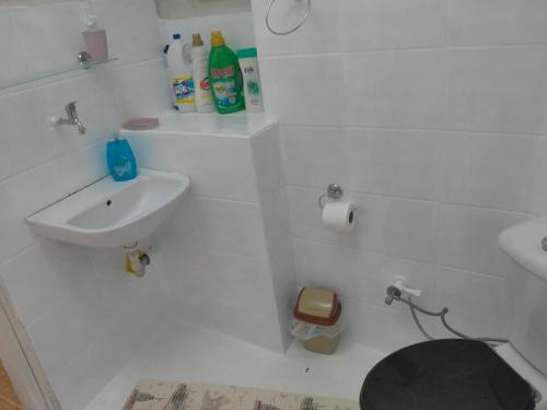 a white bathroom with a sink and a toilet at 2 bedrooms central area located appartment 1floor in Istanbul