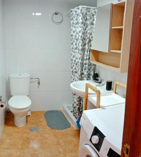 a bathroom with a toilet and a sink at EL MORRO SEA VIEW APARTMENT in San Agustin