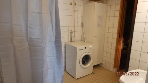 a washer and dryer in a small bathroom at Gasthouse Oulu in Oulu