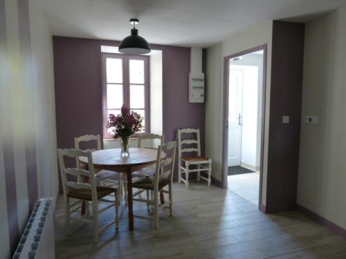 a dining room with a table and chairs and a window at L'Echappée Belle Périgord in Cercles