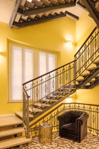 a living room with a spiral staircase and a couch at Antica Locanda Leonardo in Milan