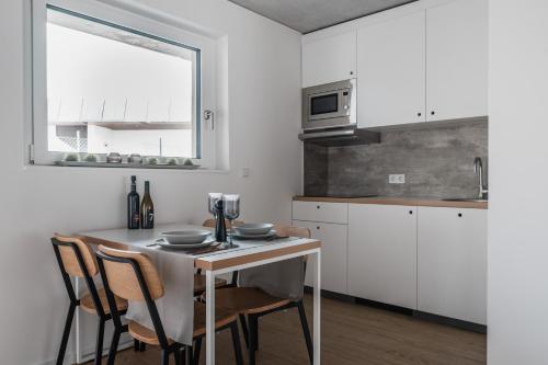 a kitchen with a table and chairs and a window at CLOUD N°7 STUDIOS in Tübingen