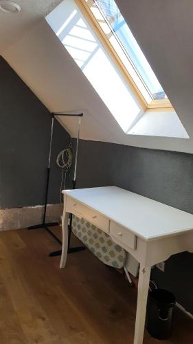 a desk in a attic with a skylight at Posti Apartment in Viljandi