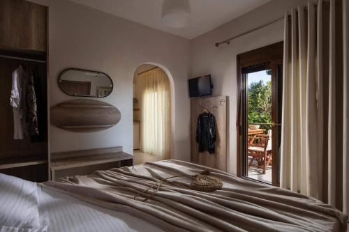a bedroom with a bed and a view of a patio at Tsamakdas House in Toroni