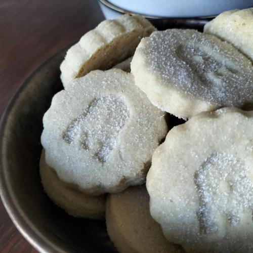 a bowl of sugar covered donuts on a table at The Castle Inn in Ebbw Vale