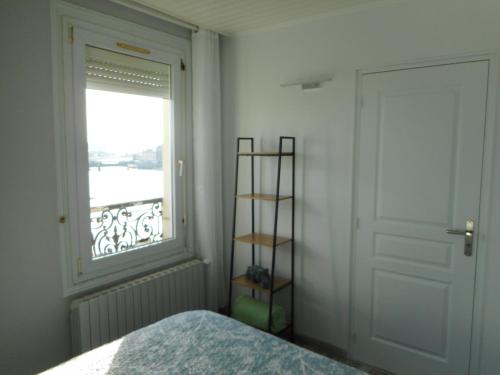 - une chambre avec un lit à côté d'une fenêtre dans l'établissement Superbe vue mer Quai 39, au Tréport