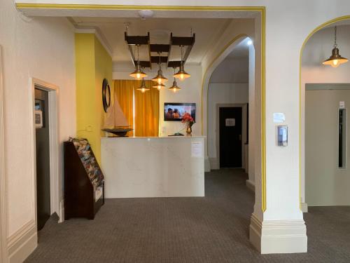 a hallway with a kitchen and a living room at Pearl & Pebbles Eastbourne in Eastbourne