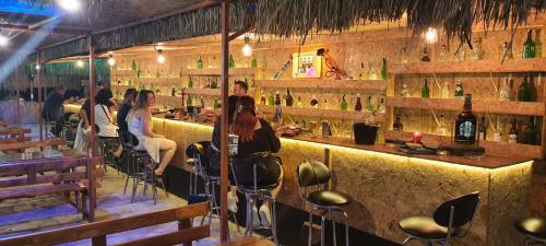 a group of people sitting at a bar at Grand Yayla Hotel in Cesme