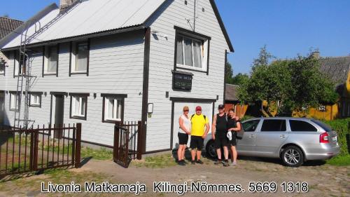 a group of people standing in front of a house at Livonia Matkamaja in Kilingi-Nõmme
