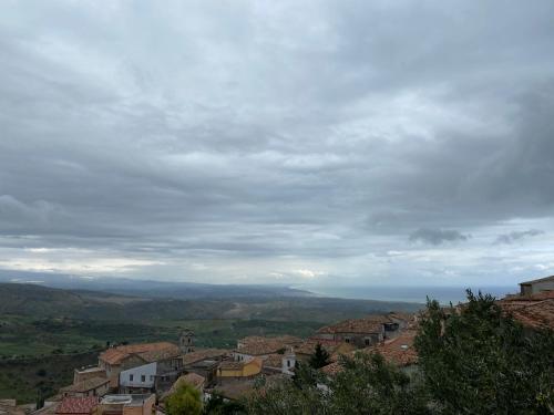 a view of a town on a hill with a cloudy sky at Luce del Sole in Montepaone Lido