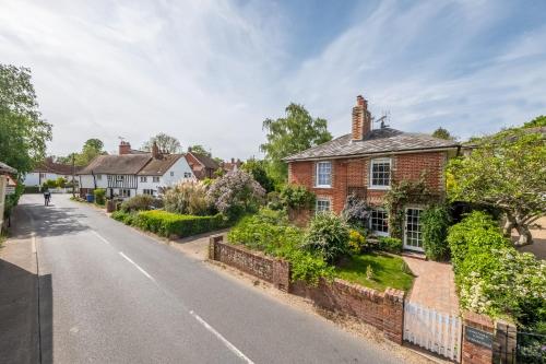 a brick house on the side of a street at Adorable cottage with a log burner in heavenly village - Constable Lodge in Nayland