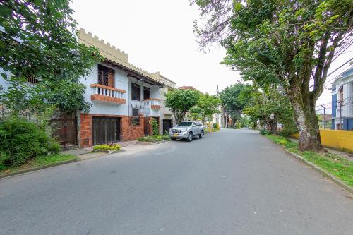 a car parked on the side of a street at Ayenda Sarayu House in Medellín