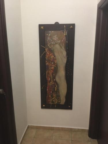 a painting of a woman on a wall at Apartments Villa Effie in Paralia Katerinis