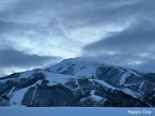 a mountain with snow on top of it at The Guest House Japan Hakuba in Hakuba