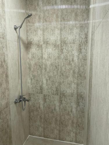 a shower with a glass door in a bathroom at Yolyans Hotel in Goris