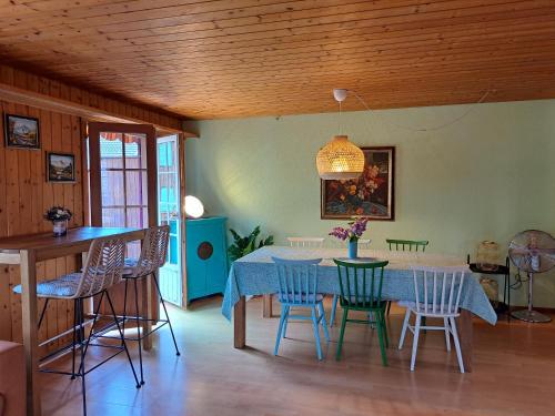 a dining room with a blue table and chairs at Sawasdee Swiss Chalet Wilderswil in Wilderswil