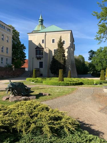 a building with a statue in front of it at Willa Witkacy in Słupsk