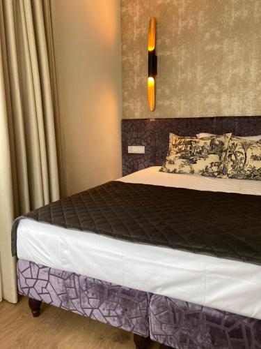 a bedroom with a bed with a black comforter at Willa Witkacy in Słupsk