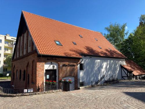 a large brick building with a large garage at Willa Witkacy in Słupsk