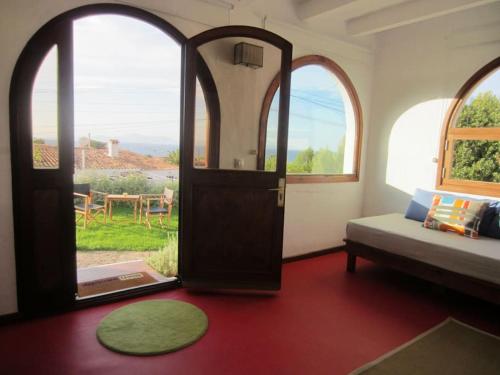 a room with a door and a couch and a table at Tranquility?JUST RELAX on the NON-TOURISTIC COAST in Colonia de Sant Pere
