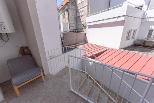 a chair sitting on the balcony of a building at Terro Collection - Eça de Queirós in Braga