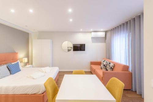 a hotel room with two beds and a couch at Terro Collection - Eça de Queirós in Braga