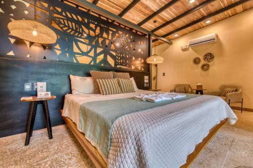 a bedroom with a large bed in a room at awā Beachfront Hotel in Puerto Viejo