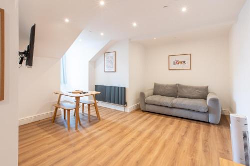 a living room with a couch and a table at Banc Apartment 2 in Porthmadog